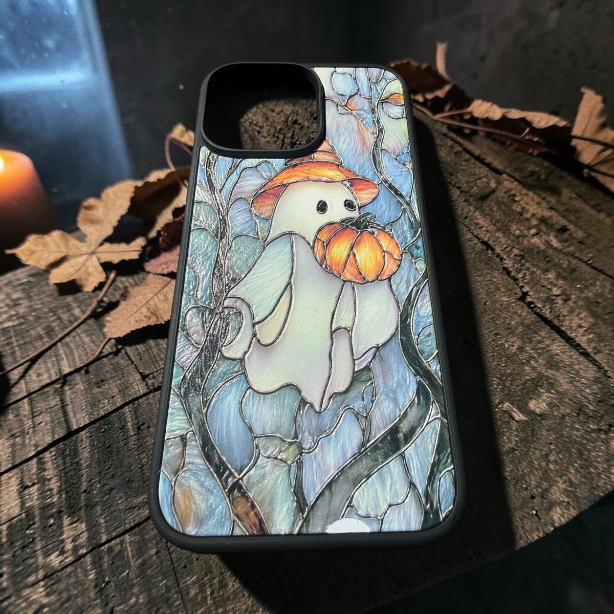 Ghost and pumpkin iPhone case displayed at an angle